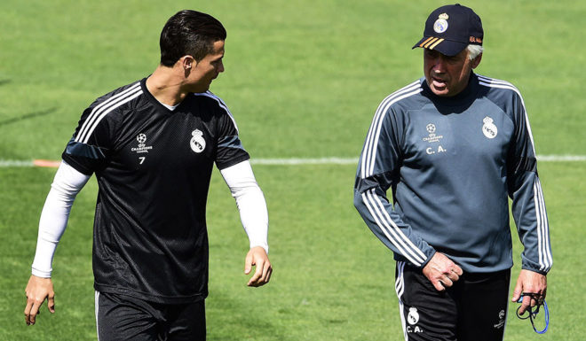 Real Madrid's Portuguese forward Cristiano Ronaldo (L) speaks with Real Madrid's Italian coach Carlo Ancelotti during a training session at Valdebebas training ground in Madrid on May 12, 2015, on the eve of the UEFA Champions League semi-final second leg football match Real Madrid CF vs Juventus. AFP PHOTO/ GERARD JULIEN (Photo credit should read GERARD JULIEN/AFP/Getty Images)