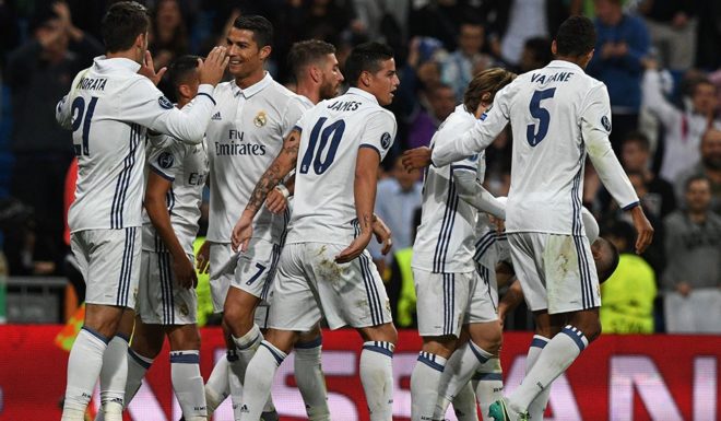 Real Madrid's forward Alvaro Morata (L) is congratulated by Real Madrid's Portuguese forward Cristiano Ronaldo (C) and his teammates after scoring during the UEFA Champions League football match Real Madrid CF vs Sporting CP at the Santiago Bernabeu stadium in Madrid on September 14, 2016. Real Madrid won 2-1. / AFP / GERARD JULIEN (Photo credit should read GERARD JULIEN/AFP/Getty Images)