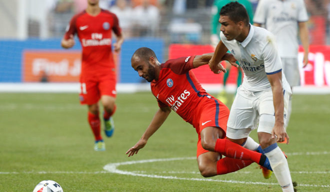 Real Madrid midfielder Carlos Henrique Casemiro (R) knocks Paris Saint-Germain midfielder Lucas (L) to the ground during an International Champions Cup soccer match in Columbus, Ohio on July 27, 2016. / AFP / Jay LaPrete (Photo credit should read JAY LAPRETE/AFP/Getty Images)