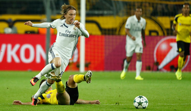 Dortmund's midfielder Julian Weigl (down) fouls Real Madrid's Croatian midfielder Luka Modric during the UEFA Champions League first leg football match between Borussia Dortmund and Real Madrid at BVB stadium in Dortmund, on September 27, 2016. / AFP / Odd ANDERSEN (Photo credit should read ODD ANDERSEN/AFP/Getty Images)