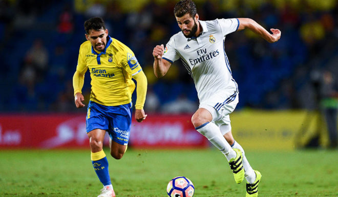 LAS PALMAS, SPAIN - SEPTEMBER 24: Nacho Fernandez of Real Madrid CF competes for the ball with Vicente Gomez of UD Las Palmas during the La Liga match between UD Las Palmas and Real Madrid CF on September 24, 2016 in Las Palmas, Spain. (Photo by David Ramos/Getty Images)