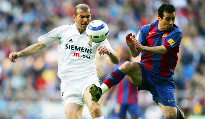 MADRID, SPAIN: Real Madrid's French Zinedine Zidane (L) vies with Barcelona's country fellowman Ludovic Giuly (R) during their Premier League football match in Santiago Bernabeu stadium in Madrid, 10 April 2005. AFP PHOTO/ Pierre-Philippe MARCOU (Photo credit should read PIERRE-PHILIPPE MARCOU/AFP/Getty Images)