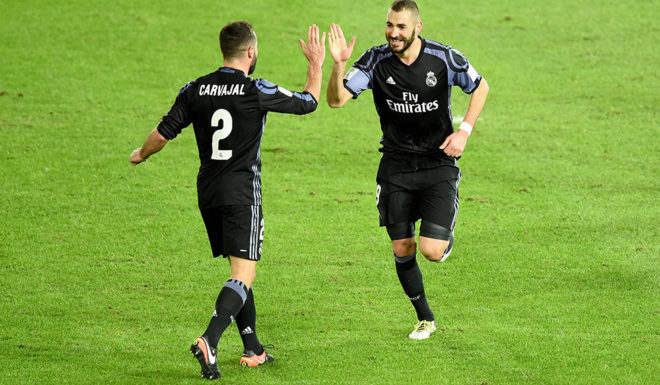 Real Madrid's forward Karim Benzema (R) is congratulated by teammate Daniel Carvajal (#2) after scoring a goal during the Club World Cup semi-final football match between Club America of Mexico and Real Madrid of Spain at Yokohama International stadium in Yokohama on December 15, 2016. / AFP / TORU YAMANAKA (Photo credit should read TORU YAMANAKA/AFP/Getty Images)