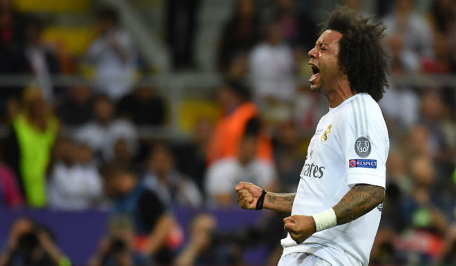 Real Madrid's Brazilian defender Marcelo celebrates after Real Madrid won the UEFA Champions League final football match over Atletico Madrid at San Siro Stadium in Milan, on May 28, 2016. / AFP / GERARD JULIEN (Photo credit should read GERARD JULIEN/AFP/Getty Images)