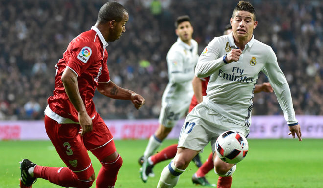Sevilla's Brazilian defender Mariano Ferreira (L) vies with Real Madrid's Colombian midfielder James Rodriguez during the Spanish Copa del Rey (King's Cup) round of 16 first leg football match Real Madrid CF vs Sevilla FC at the Santiago Bernabeu stadium in Madrid on January 4, 2017. / AFP / GERARD JULIEN (Photo credit should read GERARD JULIEN/AFP/Getty Images)