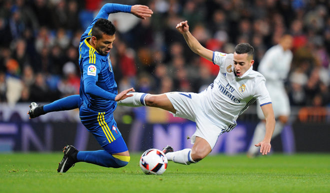 MADRID, SPAIN - JANUARY 18: Lucas Vazquez of Real Madrid is tackled by Gustavo Cabral of Celta de Vigo during the Copa del Rey Quarter Final, First Leg match between Real Madrid CF and Celta Vigo at Bernabeu on January 18, 2017 in Madrid, Spain. (Photo by Denis Doyle/Getty Images)