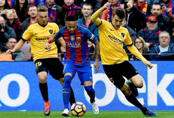 Barcelona's Brazilian forward Neymar (c) vies with Malaga's defender Diego Llorente (R) and Malaga's midfielder Ontiveros (L) during the Spanish league football match between FC Barcelona and Malaga CF at the Camp Nou stadium in Barcelona, on November 19, 2016. / AFP / LLUIS GENE (Photo credit should read LLUIS GENE/AFP/Getty Images)