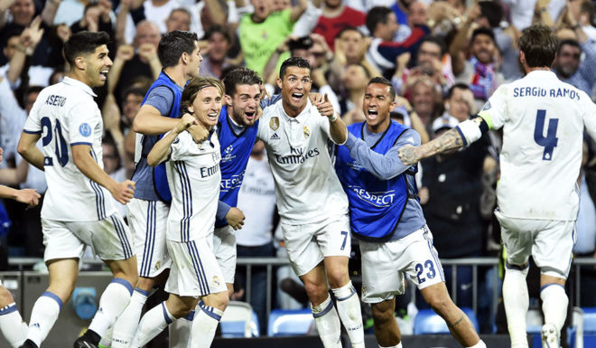 Real Madrid's Portuguese forward Cristiano Ronaldo (C) celebrates after scoring during the UEFA Champions League quarter-final second leg football match Real Madrid vs FC Bayern Munich at the Santiago Bernabeu stadium in Madrid in Madrid on April 18, 2017. / AFP PHOTO / GERARD JULIEN (Photo credit should read GERARD JULIEN/AFP/Getty Images)