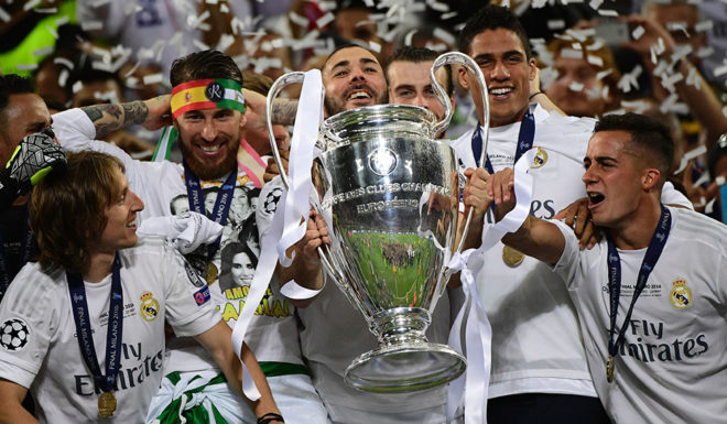 Real Madrid's French forward Karim Benzema (C) lifts the trophy after Real Madrid won the UEFA Champions League final football match between Real Madrid and Atletico Madrid at San Siro Stadium in Milan, on May 28, 2016. / AFP / PIERRE-PHILIPPE MARCOU (Photo credit should read PIERRE-PHILIPPE MARCOU/AFP/Getty Images)