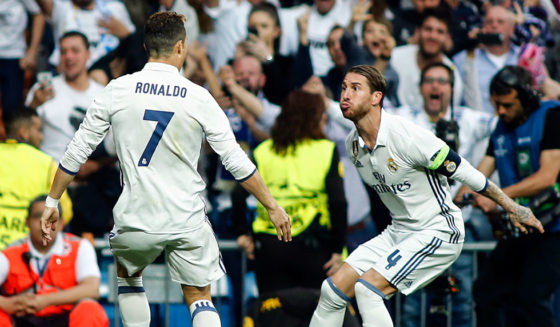 Real Madrid's Portuguese forward Cristiano Ronaldo (L) celebrates a goal with Real Madrid's defender Sergio Ramos during the UEFA Champions League semifinal first leg football match Real Madrid CF vs Club Atletico de Madrid at the Santiago Bernabeu stadium in Madrid, on May 2, 2017. / AFP PHOTO / OSCAR DEL POZO (Photo credit should read OSCAR DEL POZO/AFP/Getty Images)