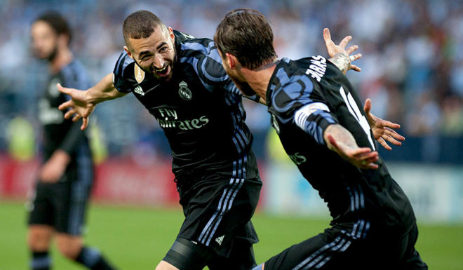 Real Madrid's French forward Karim Benzema (L) celebrates a goal with Real Madrid's defender Sergio Ramos during the Spanish league football match Malaga CF vs Real Madrid CF at La Rosaleda stadium in Malaga on May 21, 2017. / AFP PHOTO / SERGIO CAMACHO (Photo credit should read SERGIO CAMACHO/AFP/Getty Images)