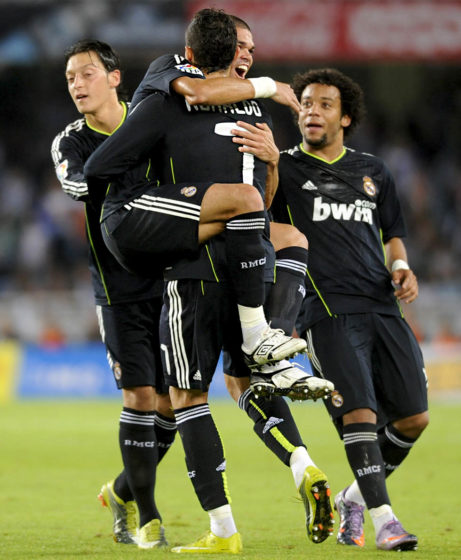 Real Madrid's Portuguese defender Pepe (2L) celebrates with teammate Portuguese forward Cristiano Ronaldo (2R) after scoring thanks to a kick from Ronaldo during a Spanish league football match against Real Sociedad on September 18, 2010, at the Anoeta stadium in San Sebastian. AFP PHOTO / Ander Gillenea (Photo credit should read ANDER GILLENEA/AFP/Getty Images)