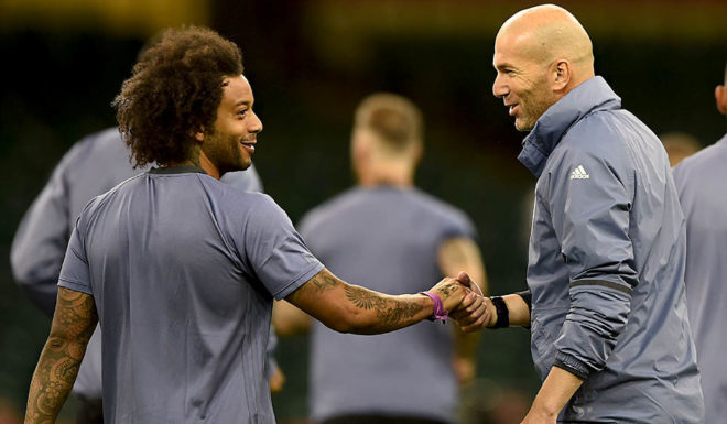 Real Madrid's French coach Zinedine Zidane (R) speaks with Real Madrid's Brazilian defender Marcelo during a training session at The Principality Stadium in Cardiff, on June 2, 2017, on the eve of the UEFA Champions League final football match between Juventus and Real Madrid. / AFP PHOTO / Filippo MONTEFORTE (Photo credit should read FILIPPO MONTEFORTE/AFP/Getty Images)