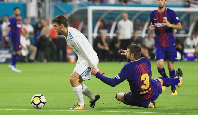 MIAMI GARDENS, FL - JULY 29: Mateo Kovacic #16 of Real Madrid gets past Gerard Pique #3 of Barcelona on his way to scoring a goal in the first half against the Barcelona during their International Champions Cup 2017 match at Hard Rock Stadium on July 29, 2017 in Miami Gardens, Florida. (Photo by Mike Ehrmann/Getty Images)