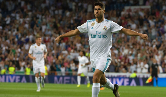 Real Madrid's midfielder Marco Asensio celebrates after scoring during the Spanish league football match Real Madrid CF vs Valencia CF at the Santiago Bernabeu stadium in Madrid on August 27, 2017. / AFP PHOTO / CURTO DE LA TORRE (Photo credit should read CURTO DE LA TORRE/AFP/Getty Images)
