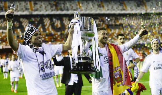 Real Madrid's Portuguese defender Pepe (L) and Real Madrid's defender Sergio Ramos hold the trophy after winning the Spanish Copa del Rey (King's Cup) final "Clasico" football match FC Barcelona vs Real Madrid CF at the Mestalla stadium in Valencia on April 16, 2014. Real Madrid won the match 2-1. AFP PHOTO/ JAVIER SORIANO (Photo credit should read JAVIER SORIANO/AFP/Getty Images)