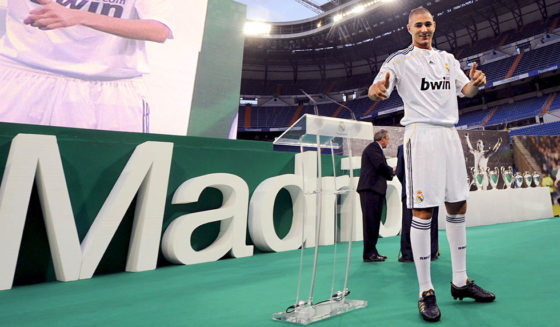 Real Madrid's new football player French Karim Benzema waves to supporters during his official presentation at the Santiago Bernabeu stadium in Madrid on July 9, 2009. Benzema, who has been compared to former French international and Real star Zinedine Zidane, was the first new player who Real president Florentino Perez signed after he returned to the helm of the club in June. AFP PHOTO / PIERRE-PHILIPPE MARCOU (Photo credit should read PIERRE-PHILIPPE MARCOU/AFP/Getty Images)