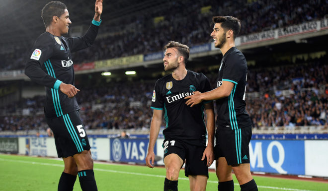 Real Madrid's forward from Spain Borja Mayoral (C) is congratulated by teammates Real Madrid's defender from France Raphael Varane (L) and Real Madrid's midfielder from Spain Marco Asensio after scoring the opening goal during the Spanish league football match Real Sociedad vs Real Madrid CF at the Anoeta stadium in San Sebastian on September 17, 2017. / AFP PHOTO / ANDER GILLENEA (Photo credit should read ANDER GILLENEA/AFP/Getty Images)