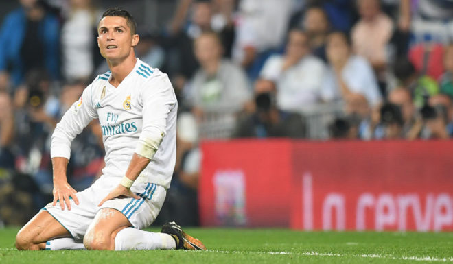 Real Madrid's forward from Portugal Cristiano Ronaldo kneels on the field during the Spanish league football match Real Madrid CF against Real Betis at the Santiago Bernabeu stadium in Madrid on September 20, 2017. / AFP PHOTO / GABRIEL BOUYS (Photo credit should read GABRIEL BOUYS/AFP/Getty Images)