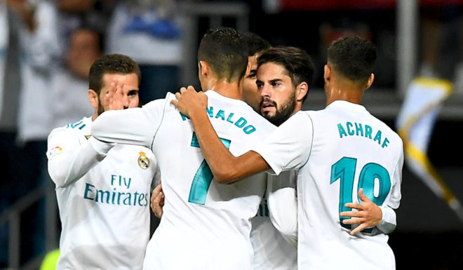 Real Madrid's midfielder Isco (2nd-R) is congratulated by teammates after scoring a goal during the Spanish league football match Real Madrid CF vs RCD Espanyol at the Santiago Bernabeu stadium in Madrid on October 1, 2017. / AFP PHOTO / GABRIEL BOUYS (Photo credit should read GABRIEL BOUYS/AFP/Getty Images)