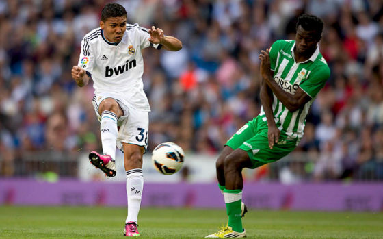 MADRID, SPAIN - APRIL 20: Casemiro (L) of Real Madrid CF competes for the ball with Nosa Iglebor (R) during the La Liga match between Real Madrid CF and Real Betis Balompie at Santiago Bernabeu Stadium on April 20, 2013 in Madrid, Spain. (Photo by Gonzalo Arroyo Moreno/Getty Images)