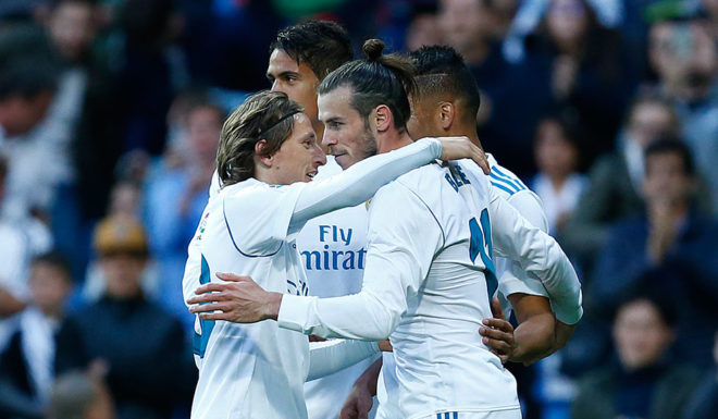 Real Madrid's Welsh forward Gareth Bale (R) celebrates a goal with teammates during the Spanish league football match between Real Madrid and Celta Vigo at the Santiago Bernabeu stadium in Madrid on May 12, 2018. (Photo by Benjamin CREMEL / AFP) (Photo credit should read BENJAMIN CREMEL/AFP/Getty Images)