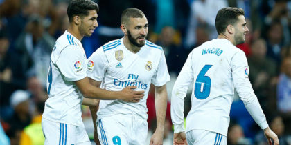 Real Madrid's Spanish-Moroccan defender Achraf Hakimi (L) celebrates a goal with Real Madrid's French forward Karim Benzema (C) and Real Madrid's Spanish defender Nacho Fernandez during the Spanish league football match between Real Madrid and Celta Vigo at the Santiago Bernabeu stadium in Madrid on May 12, 2018. (Photo by Benjamin CREMEL / AFP) (Photo credit should read BENJAMIN CREMEL/AFP/Getty Images)
