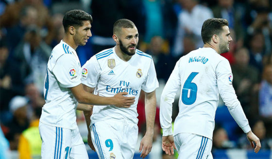 Real Madrid's Spanish-Moroccan defender Achraf Hakimi (L) celebrates a goal with Real Madrid's French forward Karim Benzema (C) and Real Madrid's Spanish defender Nacho Fernandez during the Spanish league football match between Real Madrid and Celta Vigo at the Santiago Bernabeu stadium in Madrid on May 12, 2018. (Photo by Benjamin CREMEL / AFP) (Photo credit should read BENJAMIN CREMEL/AFP/Getty Images)
