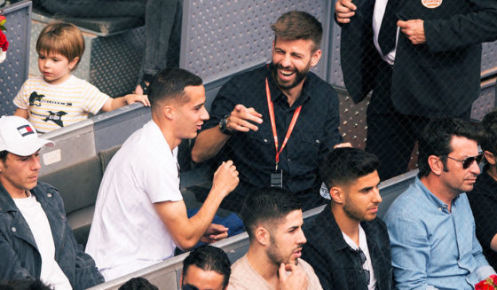 MADRID, SPAIN - MAY 11: Gerard Pique (right) of FC Barcelona has a laugh with Lucas Vazquez of Real Madrid while attending the quarterfinal match between Rafael Nadal of Spain and Dominic Thiem of Austria on day seven of Mutua Madrid Open at the Caja Magica on May 11, 2018 in Madrid, Spain. (Photo by Denis Doyle/Getty Images)