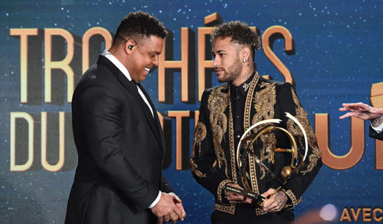 TOPSHOT - Paris Saint-Germain's Brazilian forward Neymar (R) receives the Best Ligue 1 Player award from former Brazilian international player Ronaldo during a TV show on May 13, 2018 in Paris, as part of the 27th edition of the UNFP (French National Professional Football players Union) trophy ceremony. (Photo by FRANCK FIFE / AFP) (Photo credit should read FRANCK FIFE/AFP/Getty Images)