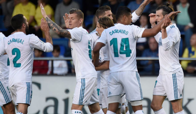 Real Madrid's Welsh forward Gareth Bale (R) celebrates with teammates after scoring a goal during the Spanish league football match between Villarreal CF and Real Madrid CF at La Ceramica stadium in Villarreal on May 19, 2018. (Photo by JOSE JORDAN / AFP) (Photo credit should read JOSE JORDAN/AFP/Getty Images)