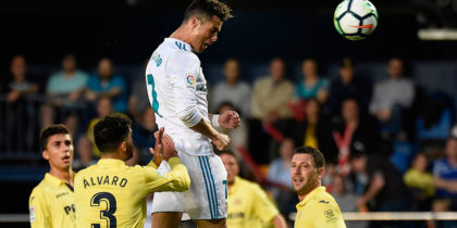 Real Madrid's Portuguese forward Cristiano Ronaldo (C) scores a header during the Spanish league football match between Villarreal CF and Real Madrid CF at La Ceramica stadium in Villarreal on May 19, 2018. (Photo by JOSE JORDAN / AFP) (Photo credit should read JOSE JORDAN/AFP/Getty Images)