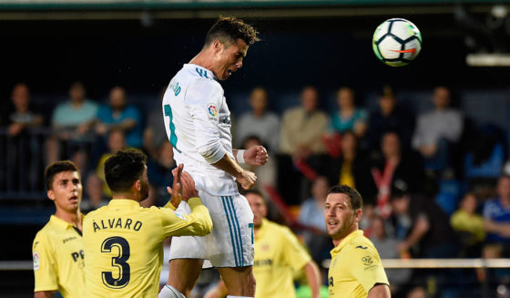 Real Madrid's Portuguese forward Cristiano Ronaldo (C) scores a header during the Spanish league football match between Villarreal CF and Real Madrid CF at La Ceramica stadium in Villarreal on May 19, 2018. (Photo by JOSE JORDAN / AFP) (Photo credit should read JOSE JORDAN/AFP/Getty Images)