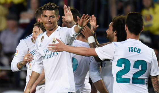 Real Madrid's Portuguese forward Cristiano Ronaldo celebrates with teammates after scoring a goal during the Spanish league football match between Villarreal CF and Real Madrid CF at La Ceramica stadium in Villarreal on May 19, 2018. (Photo by JOSE JORDAN / AFP) (Photo credit should read JOSE JORDAN/AFP/Getty Images)