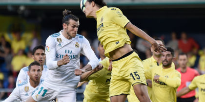 Real Madrid's Welsh forward Gareth Bale (L) heads the ball with Villarreal's Turkish forward Enes Unal during the Spanish league football match between Villarreal CF and Real Madrid CF at La Ceramica stadium in Villarreal on May 19, 2018. (Photo by JOSE JORDAN / AFP) (Photo credit should read JOSE JORDAN/AFP/Getty Images)