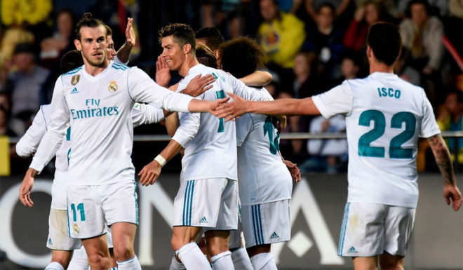 Real Madrid's Portuguese forward Cristiano Ronaldo (C) celebrates with teammates after scoring a goal during the Spanish league football match between Villarreal CF and Real Madrid CF at La Ceramica stadium in Villarreal on May 19, 2018. (Photo by JOSE JORDAN / AFP) (Photo credit should read JOSE JORDAN/AFP/Getty Images)