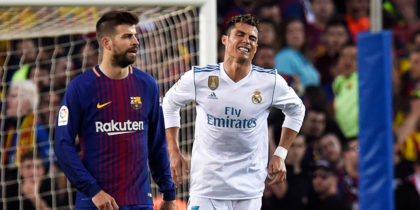 BARCELONA, SPAIN - MAY 06: Cristiano Ronaldo of Real Madrid (R) is injured as he scores his sides first goal during the La Liga match between Barcelona and Real Madrid at Camp Nou on May 6, 2018 in Barcelona, Spain. (Photo by Alex Caparros/Getty Images)