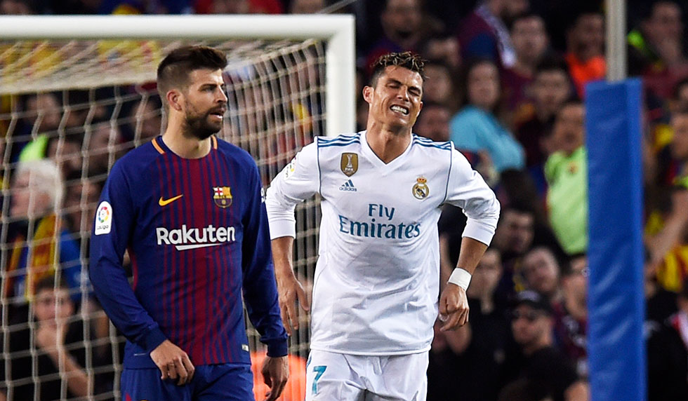 BARCELONA, SPAIN - MAY 06: Cristiano Ronaldo of Real Madrid (R) is injured as he scores his sides first goal during the La Liga match between Barcelona and Real Madrid at Camp Nou on May 6, 2018 in Barcelona, Spain. (Photo by Alex Caparros/Getty Images)