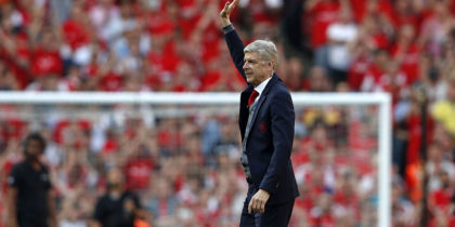 Arsenal's French manager Arsene Wenger waves to supporters at a ceremony on the pitch after the English Premier League football match between Arsenal and Burnley at the Emirates Stadium in London on May 6, 2018. - Arsene Wenger bids farewell to a stadium he helped to build in more ways than one when he leads Arsenal at the Emirates for the final time at home to Burnley on Sunday. Wenger's final season after 22 years in charge is destined to end in disappointment after Thursday's Europa League semi-final exit. (Photo by Adrian DENNIS / AFP) / RESTRICTED TO EDITORIAL USE. No use with unauthorized audio, video, data, fixture lists, club/league logos or 'live' services. Online in-match use limited to 75 images, no video emulation. No use in betting, games or single club/league/player publications. / (Photo credit should read ADRIAN DENNIS/AFP/Getty Images