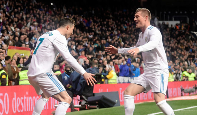 Real Madrid's Portuguese forward Cristiano Ronaldo (L) celebrates a goal with Real Madrid's German midfielder Toni Kroos during the Spanish League football match between Real Madrid CF and Girona FC at the Santiago Bernabeu stadium in Madrid on March 18, 2018. / AFP PHOTO / JAVIER SORIANO (Photo credit should read JAVIER SORIANO/AFP/Getty Images)
