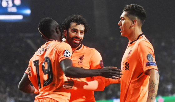 Liverpool's Senegalese midfielder Sadio Mane (L) celebrates with Liverpool's Egyptian midfielder Mohamed Salah and Liverpool's Brazilian midfielder Roberto Firmino (R) after scoring their third goal during the UEFA Champions League round of sixteen first leg football match between FC Porto and Liverpool at the Dragao stadium in Porto, Portugal on February 14, 2018.