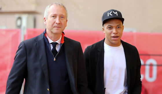 Paris Saint-Germain's French forward Kylian Mbappe (R) arrives with Monaco's Russian Vice club President Vadim Vasilyev (L) before the French L1 football match Monaco vs Nantes on April 7, 2018 at the Louis II Stadium in Monaco. / AFP PHOTO / VALERY HACHE (Photo credit should read VALERY HACHE/AFP/Getty Images)