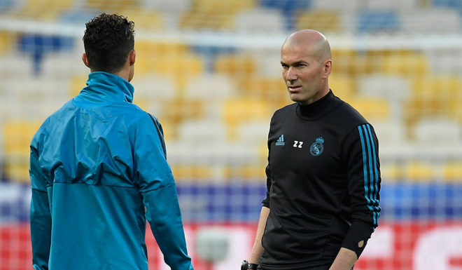 Real Madrid's French coach Zinedine Zidane (R) looks at Real Madrid's Portuguese forward Cristiano Ronaldo (L) during a Real Madrid team training session at the Olympic Stadium in Kiev, Ukraine on May 25, 2018, on the eve of the UEFA Champions League final football match between Liverpool and Real Madrid. (Photo by LLUIS GENE / AFP) (Photo credit should read LLUIS GENE/AFP/Getty Images)