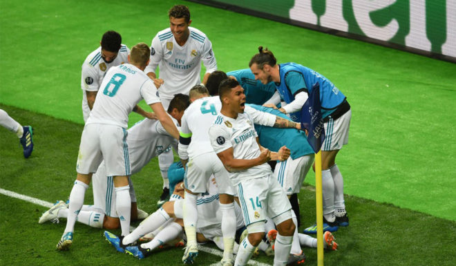 KIEV, UKRAINE - MAY 26: Karim Benzema of Real Madrid celebrates scoring his side's first goal with team mates during the UEFA Champions League Final between Real Madrid and Liverpool at NSC Olimpiyskiy Stadium on May 26, 2018 in Kiev, Ukraine. (Photo by Mike Hewitt/Getty Images)
