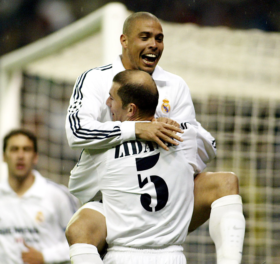Real Madrid's Brazilian Ronaldo (up) celebrates with French teammate Zinedine Zidane after scoring their team's second goal during their Champions League match group C in Santiago Bernabeu stadium of Madrid, 189 February 2003. Real Madrid won 2-1. AFP PHOTO/ JAVIER SORIANO. (Photo credit should read JAVIER SORIANO/AFP/Getty Images)