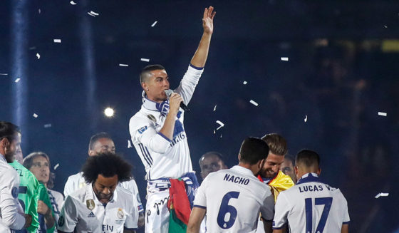 Real Madrid's Portuguese forward Cristiano Ronaldo (C) speaks as he celebrates with teammates the team's win, at the Santiago Bernabeu stadium in Madrid on June 4, 2017 after winning the UEFA Champions League football match final Juventus vs Real Madrid CF held at the National Stadium of Wales in Cardiff on June 3, 2017. / AFP PHOTO / Oscar DEL POZO (Photo credit should read OSCAR DEL POZO/AFP/Getty Images)
