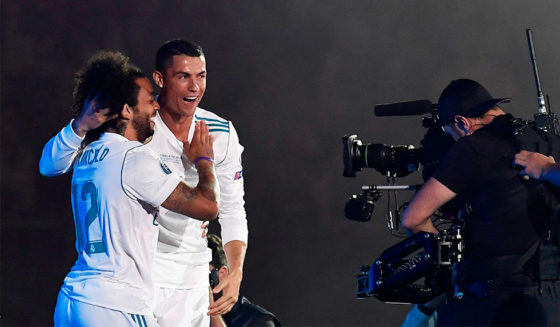 Real Madrid's Brazilian defender Marcelo (L) and Real Madrid's Portuguese forward Cristiano Ronaldo celebrate at the Santiago Bernabeu stadium in Madrid on May 27, 2018 during a victory ceremony after Real Madrid won its third Champions League title in a row in Kiev. (Photo by OSCAR DEL POZO / AFP) (Photo credit should read OSCAR DEL POZO/AFP/Getty Images)