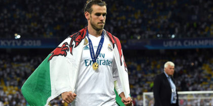 KIEV, UKRAINE - MAY 26: Gareth Bale of Real Madrid walks off the pitch with a Wales flag drapped over him after the UEFA Champions League Final between Real Madrid and Liverpool at NSC Olimpiyskiy Stadium on May 26, 2018 in Kiev, Ukraine. (Photo by David Ramos/Getty Images)