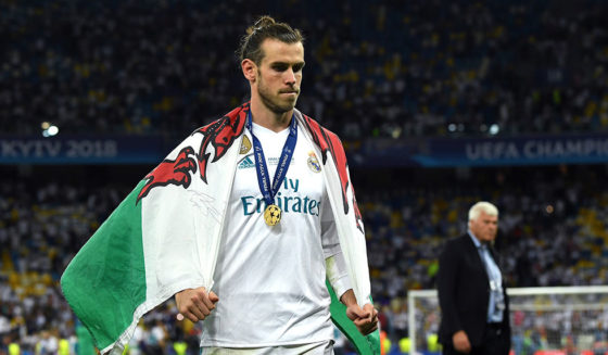 KIEV, UKRAINE - MAY 26: Gareth Bale of Real Madrid walks off the pitch with a Wales flag drapped over him after the UEFA Champions League Final between Real Madrid and Liverpool at NSC Olimpiyskiy Stadium on May 26, 2018 in Kiev, Ukraine. (Photo by David Ramos/Getty Images)