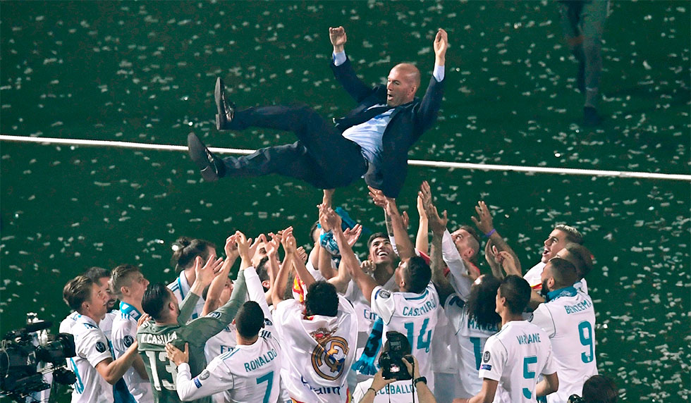 Real Madrid's players toss Real Madrid's French coach Zinedine Zidane at the Santiago Bernabeu stadium in Madrid on May 27, 2018 during a victory ceremony after Real Madrid won its third Champions League title in a row in Kiev. (Photo by GABRIEL BOUYS / AFP) (Photo credit should read GABRIEL BOUYS/AFP/Getty Images)